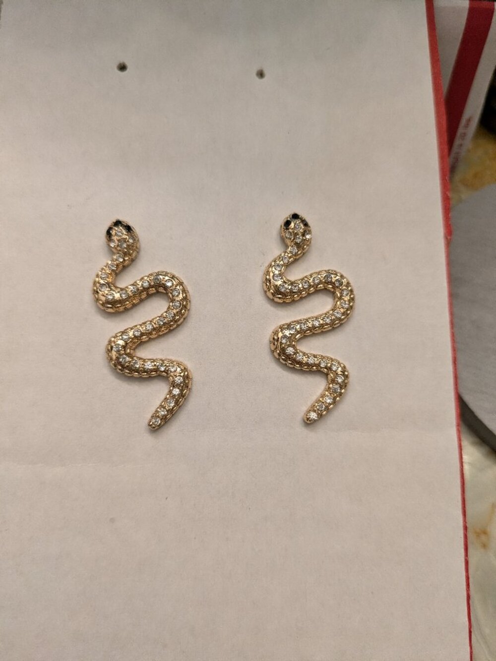 Gold and diamond snake stud earrings with black head bling